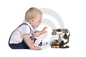 Baby boy with old-fashioned telephone