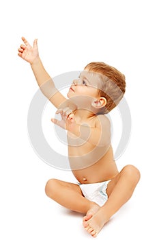 Baby boy in pampers pointing up