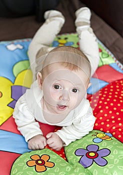 Baby boy on play blanket