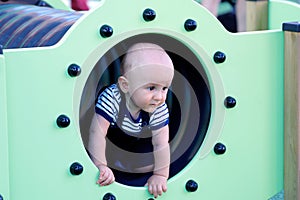 Baby Boy In A Playground Tunnel