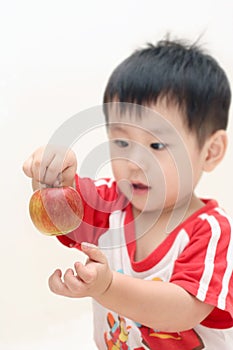 Baby boy playing an apple