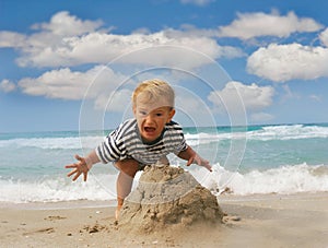 Baby boy playing on beach