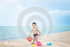 baby boy playing with beach toys