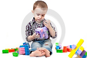 Baby boy playing with blocks toys isolated on white background