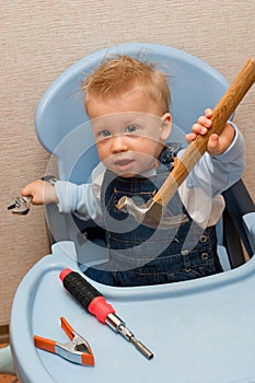 Baby boy playing with hammer