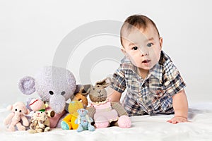 Baby boy playing with knitted toys in