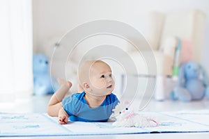 Baby boy playing and learning to crawl