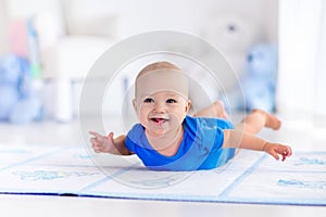 Baby boy playing and learning to crawl