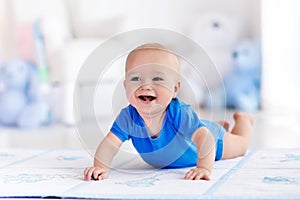 Baby boy playing and learning to crawl photo
