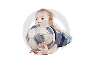 Baby boy playing with a soccer ball. Isolated on white