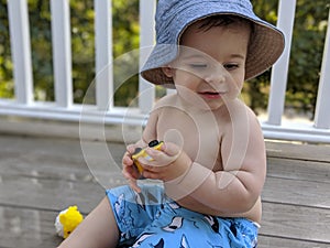 Baby boy playing in summer