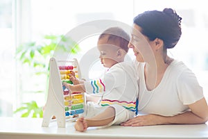 Baby boy playing with wooden abacus