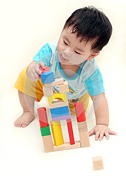 Baby boy playing wooden blocks