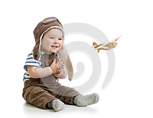 Baby boy playing with wooden plane