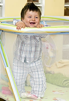 Baby boy in playpen