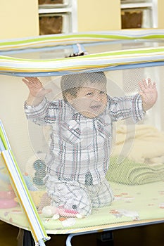 Baby boy in playpen