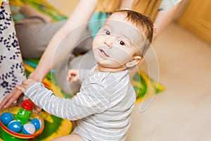 Baby boy plays in his room.