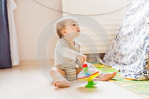 Baby boy plays in his room.