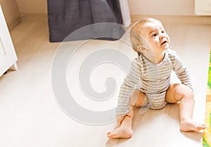 Baby boy plays in his room.