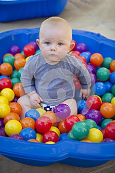 Baby boy with reusable nappy diaper in ball pond