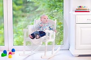 Baby boy in a rocking chair