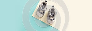 Baby boy shoes on pastel colors background, banner