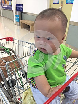 baby boy in shopping cart