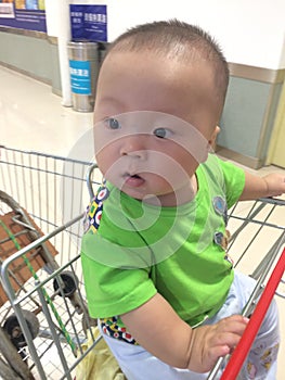 baby boy in shopping cart