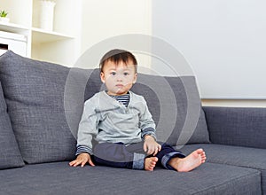Baby boy sit on sofa
