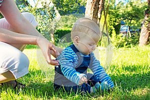 Baby boy sitiing on the grass