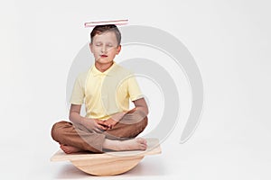 baby boy sits on a special simulator for training the vestibular apparatus.