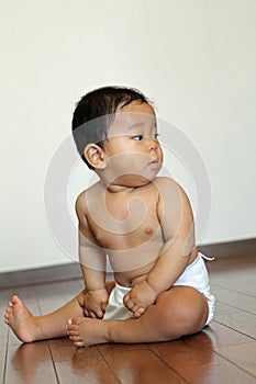 Baby boy sitting on the floor