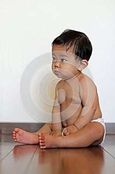 Baby boy sitting on the floor