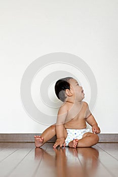 Baby boy sitting on the floor