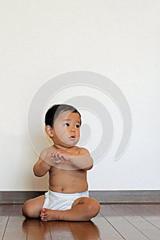 Baby boy sitting on the floor