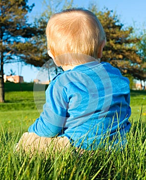 Baby boy sitting on the grass