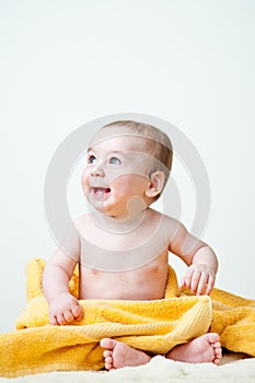 Baby Boy Sitting Wrapped in Yellow Towel