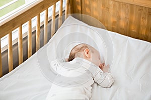 Baby boy sleeping on a cradle