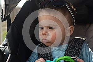 Baby boy in stroller in summertime