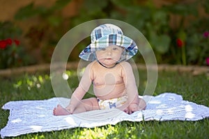 Baby boy with sunhat and cloth diaper