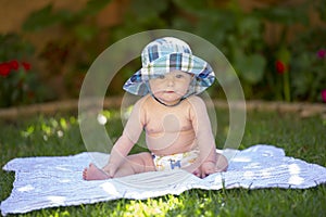Baby boy with sunhat and cloth diaper photo