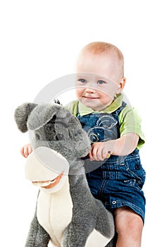 Baby boy swingning on a donkey