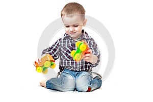 Baby boy toddler playing with toy car isolated