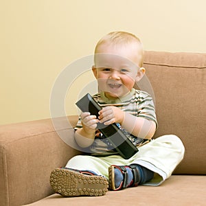 Baby boy with TV remote