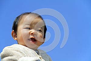 Baby boy under blue sky