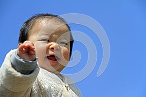 Baby boy under blue sky