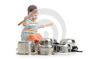 Baby boy using wooden spoons to bang pans drumset