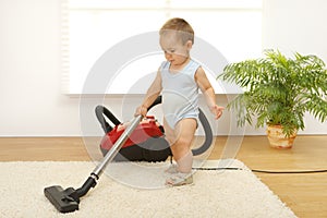 Baby boy with vacuum cleaner