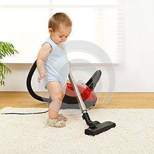 Baby boy with vacuum cleaner