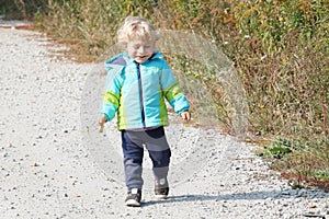 Baby boy walking through the village